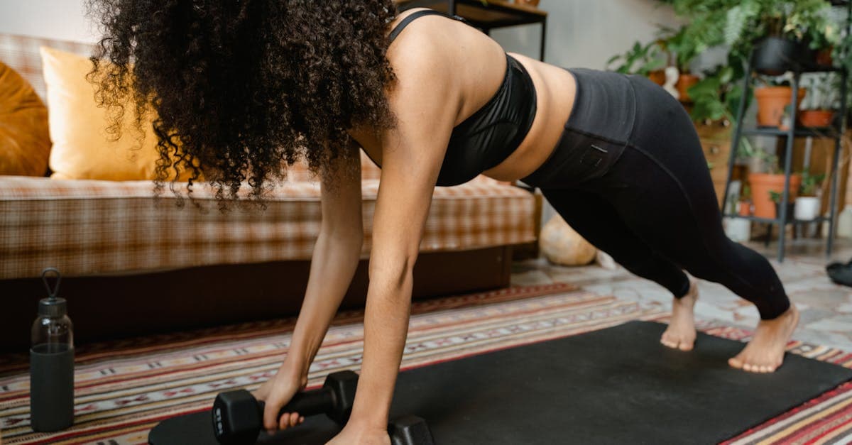 Woman doing a plank position in a black activewear.