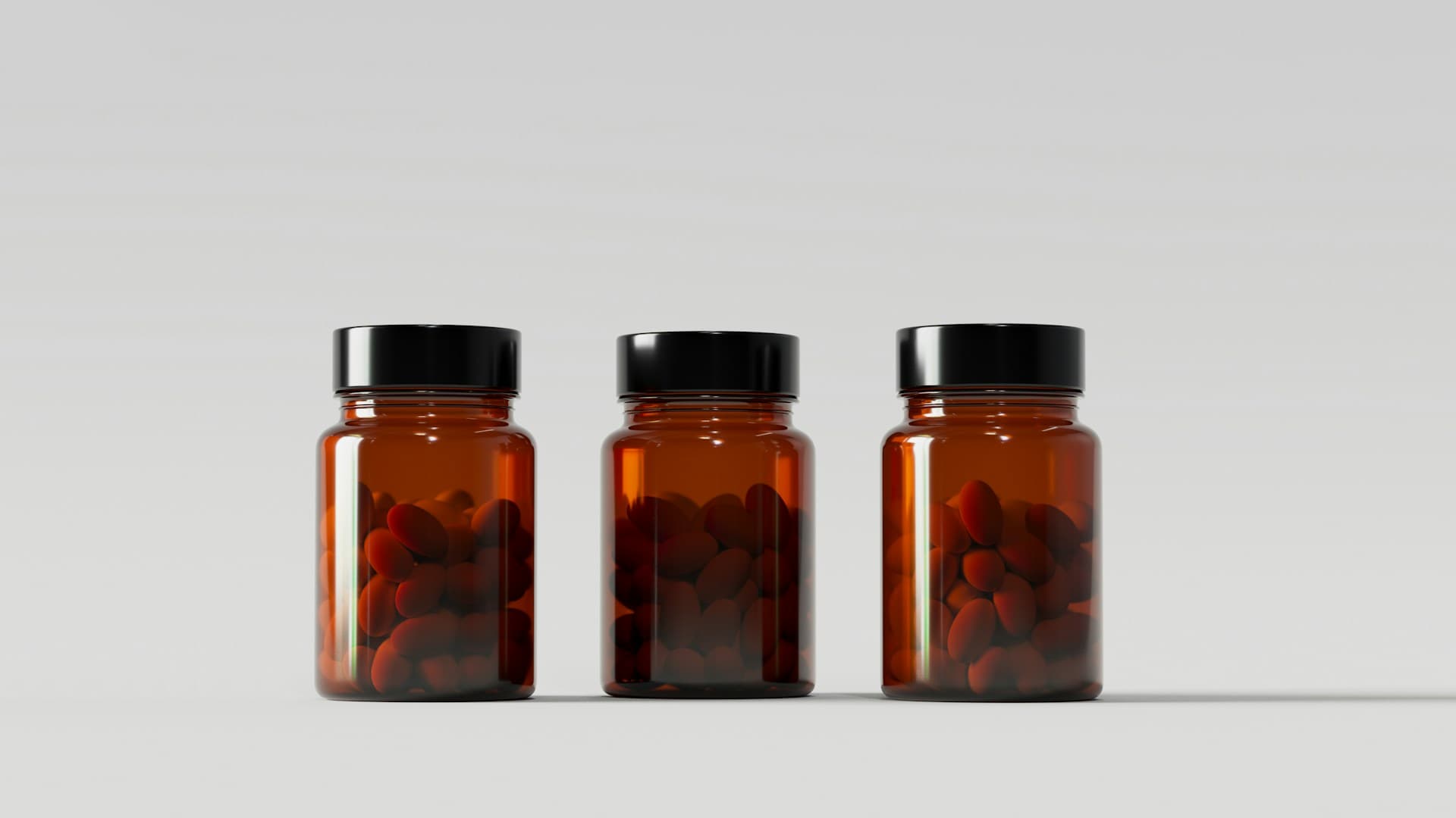 A collection of longevity supplements in capsules and bottles on a clean, modern surface.