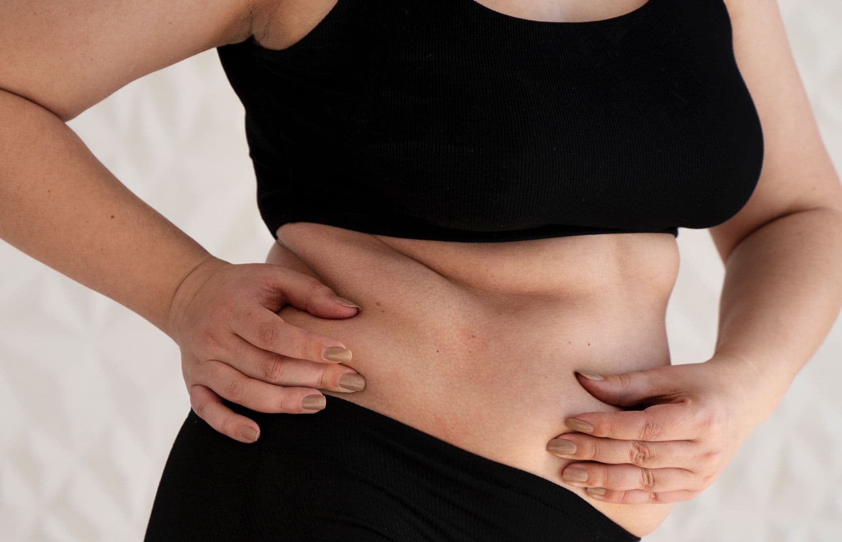 A woman holding her belly.