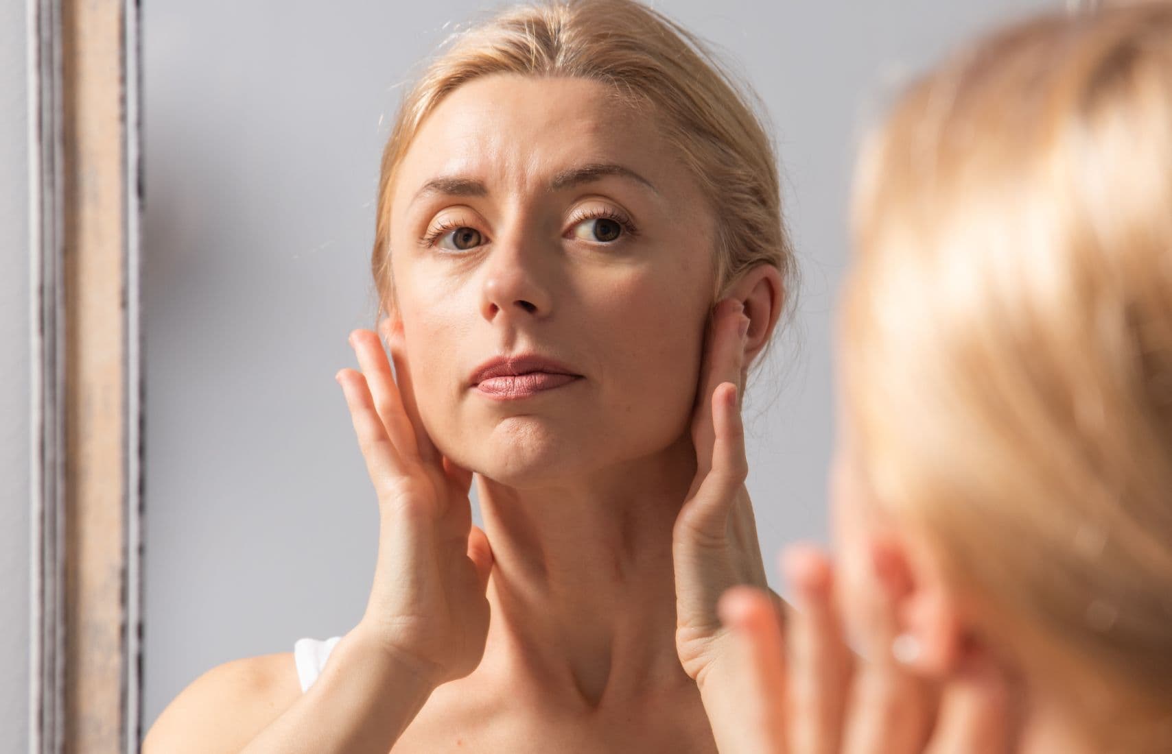 A woman following the Nord Yoga Facial Lymphatic Detox program.