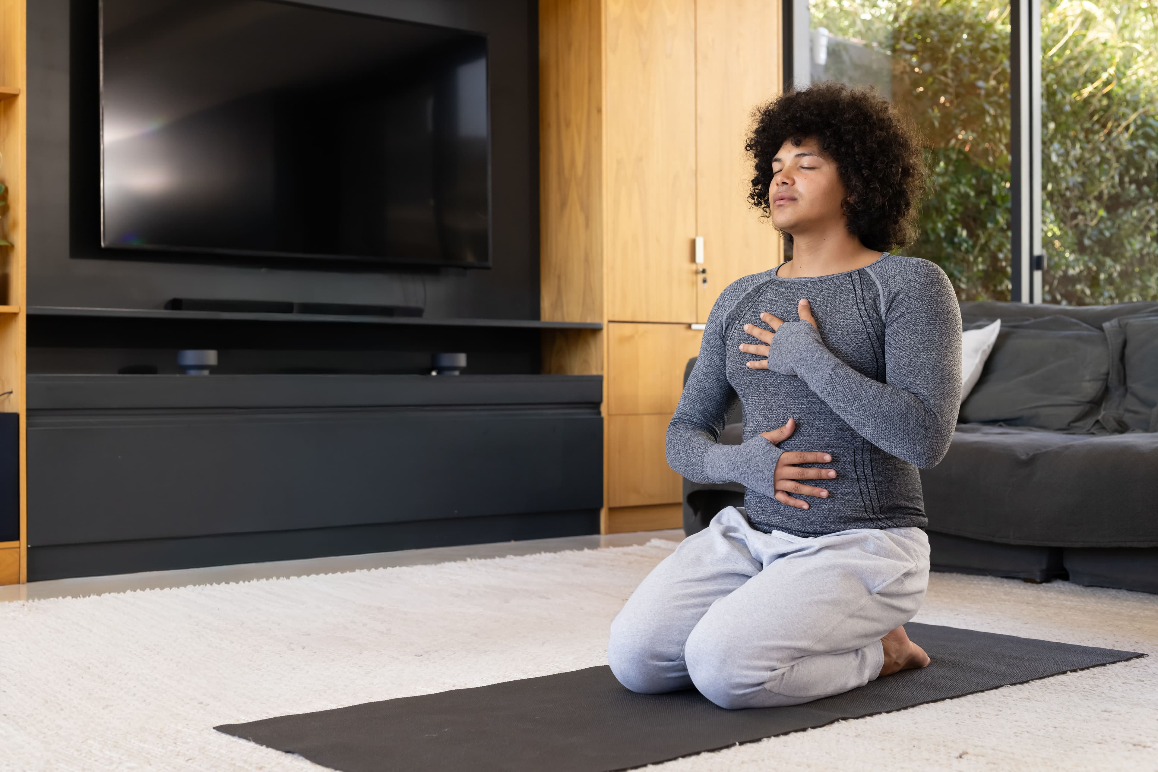 person meditating in living room