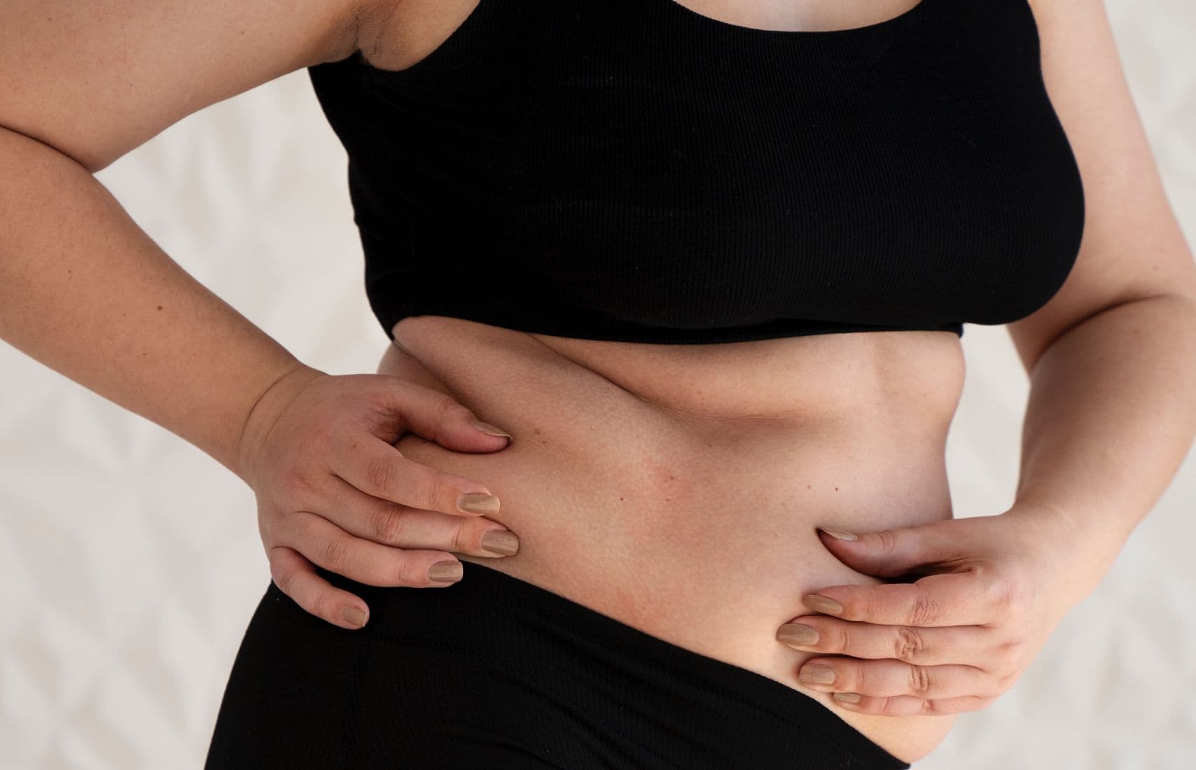 A woman holding her belly.
