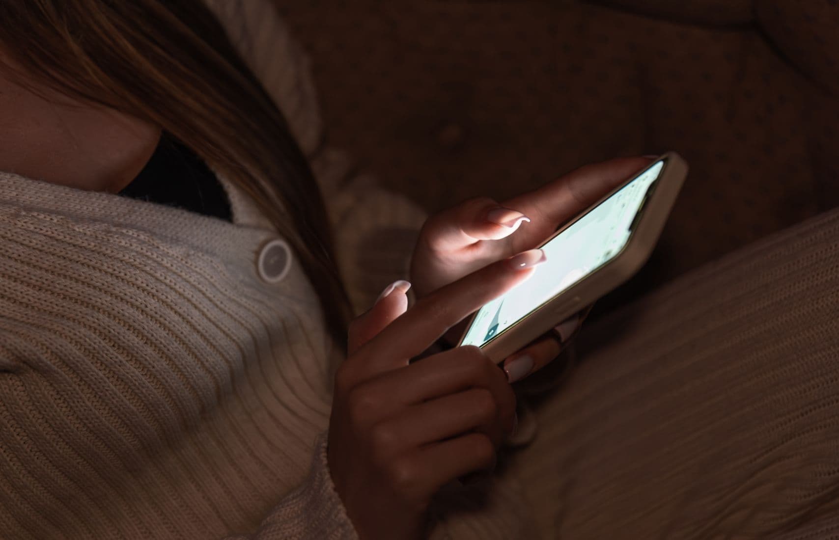A woman using a phone.