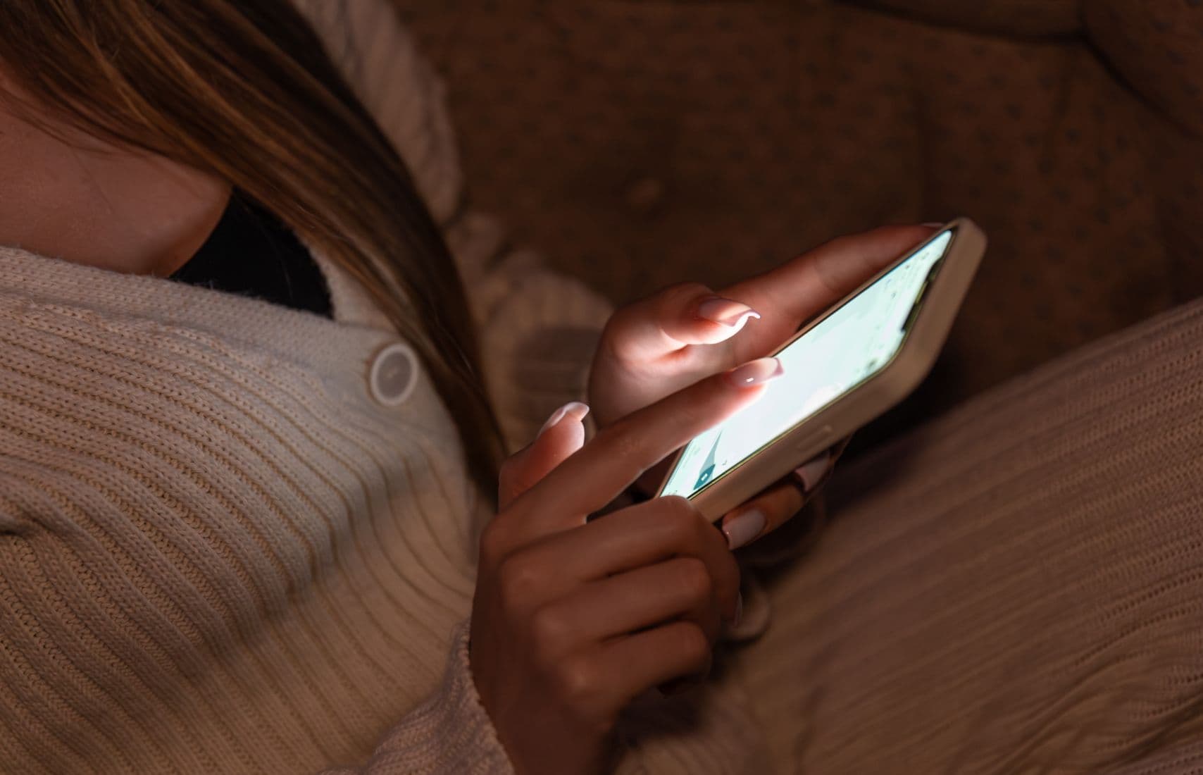 A woman using an app on her phone.