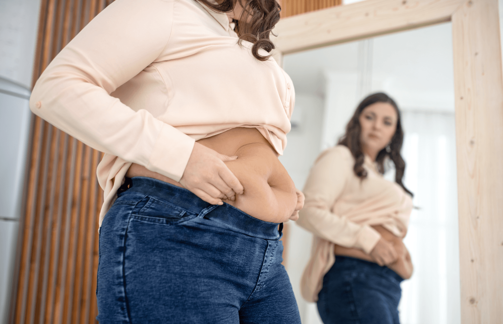 A woman looking at herself in the mirror.